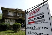 FILE PHOTO: A realtor's for sale sign stands outside a house that had been sold in Toronto, Ontario, Canada May 20, 2021. REUTERS/Chris Helgren/File Photo