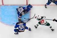 ST LOUIS, MO - MAY 08: Colton Parayko #55 and Jordan Binnington #50 of the St. Louis Blues defend the net against Kirill Kaprizov #97 of the Minnesota Wild in the second period of Game Four of the First Round of the 2022 Stanley Cup Playoffs at Enterprise Center on May 8, 2022 in St Louis, Missouri. (Photo by Joe Puetz/Getty Images)