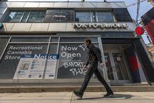A pedestrian walks by 250 King St. East, Toronto on Wednesday, May 17, 2023. Tuan  Minh Nguyen/ The Globe and Mail