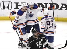 Edmonton Oilers' Leon Draisaitl (29) celebrates with Zach Hyman (18) and Ryan Nugent-Hopkins after his goal, as Los Angeles Kings' Anze Kopitar skates past during the second period in Game 6 of an NHL hockey Stanley Cup first-round playoff series in Los Angeles on Saturday, April 29, 2023. (Keith Birmingham/The Orange County Register via AP)
