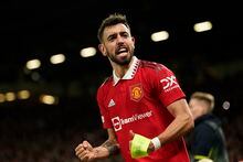 Manchester United's Bruno Fernandes celebrates after his teammate Antony scores his side's second goal during the Europa League playoff second leg soccer match between Manchester United and Barcelona at Old Trafford stadium in Manchester, England, Thursday, Feb. 23, 2023. (AP Photo/Dave Thompson)