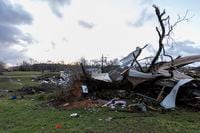 The sun rises over weather-damaged properties at the intersection of County Road 24 and 37 in Clanton, Ala.,  following a large outbreak of severe storms across the southeast, Thursday, March 18, 2021. Possible tornadoes knocked down trees, toppled power lines and damaged homes in multiple locations across the state of Alabama.  (AP Photo/Vasha Hunt)
