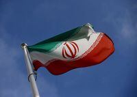 FILE PHOTO: The Iranian flag waves in front of the International Atomic Energy Agency (IAEA) headquarters in Vienna, Austria, March 1, 2021. REUTERS/Lisi Niesner/File Photo