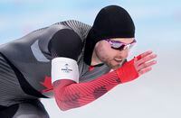 Laurent Dubreuil of Canada rounds the oval to win the silver medal in the men's 1,000 metre speedskating race at the 2022 Winter Olympics in Beijing on Friday, February 18, 2022. THE CANADIAN PRESS/Paul Chiasson