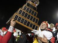 Calgary University Dinos Adam Sinagra raises the Vanier Cup after winning the U Sports Vanier Cup university football championship against the University of Montreal Carabins, in Quebec City on Nov. 23, 2019.