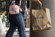 File - A shopper carries a Marshalls bag, Friday, Oct. 14, 2022, in Boston. On Tuesday, the Conference Board reports on U.S. consumer confidence for March. (AP Photo/Michael Dwyer, File)