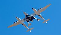 FILE - In this Feb. 13, 2020, file photo, Virgin Galactic's VSS Unity departs Mojave Air & Space Port in Mojave, Calif. for the final time as Virgin Galactic shifts its SpaceFlight operations to New Mexico. Virgin Galactic said Thursday, Nov. 5, 2020, it expects to launch its first test spaceflight from New Mexico between Nov. 19-23. "This will be the first-ever human spaceflight conducted from New Mexico," Chief Executive Officer Michael Colglazier said in a statement. (Matt Hartman via AP, File)