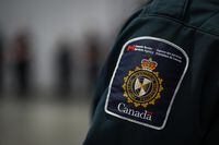 A patch is seen on the shoulder of a Canada Border Services Agency officer's uniform in Tsawwassen, B.C., Friday, Dec. 16, 2022. The Canada Border Services Agency says there are alternatives to holding immigration detainees in provincial jails after Alberta said it would no longer agree to do so. THE CANADIAN PRESS/Darryl Dyck