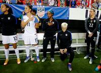 The United States' Megan Rapinoe, right, kneels next to teammates Christen Press, from left, Ali Krieger, Crystal Dunn and Ashlyn Harris as the national anthem is played before the team's exhibition soccer match against the Netherlands in Atlanta on Sept. 18, 2016.
