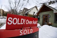 A for sale sign outside a home indicates that it has sold for over the asking price, in Ottawa, on Monday, March 1, 2021. THE CANADIAN PRESS/Justin Tang