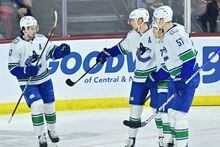 Apr 13, 2023; Tempe, Arizona, USA;  Vancouver Canucks center Elias Pettersson (40) celebrates with defenseman Tyler Myers (57) and defenseman Quinn Hughes (43) after scoring a goal in the first period against the Arizona Coyotes at Mullett Arena. Mandatory Credit: Matt Kartozian-USA TODAY Sports