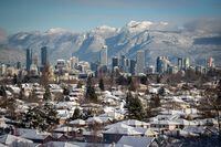 Snow-covered houses and the downtown skyline are seen with the north shore mountains in the distance, in Vancouver, on Thursday, December 30, 2021. British Columbia's Electoral Boundaries Commission is recommending the creation of six more electoral districts in the province, raising the number of ridings to 93 from the current 87. In addition to the call for six new districts reflecting areas of rapid population growth, the commission is also seeking adjustments to the boundaries of 72 other districts and changes to the names of 41 ridings. THE CANADIAN PRESS/Darryl Dyck