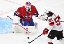 New Jersey Devils' Erik Haula (56) moves in on Montreal Canadiens goaltender Jake Allen during second period NHL hockey action in Montreal, Saturday, March 11, 2023. THE CANADIAN PRESS/Graham Hughes