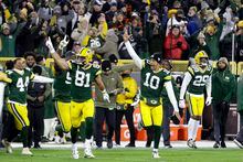 Green Bay Packers' Johnathan Abram (44), Josiah Deguara (81), Jordan Love (10) Rasul Douglas (29) and others celebrate the team's 31-28 win in overtime of an NFL football game against the Dallas Cowboys Sunday, Nov. 13, 2022, in Green Bay, Wis. (AP Photo/Mike Roemer)