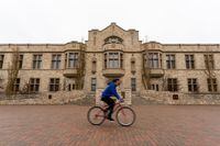 A cyclist commutes by the Peter MacKinnon Building on the University of Saskatchewan campus  in Saskatoon, Sask., Thursday, May 19, 2022. THE CANADIAN PRESS/Heywood Yu