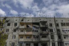 Birds fly over a damaged building in the Kherson region village of Arkhanhelske on November 3, 2022, which was formerly occupied by Russian forces. (Photo by BULENT KILIC / AFP) (Photo by BULENT KILIC/AFP via Getty Images)