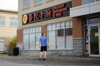 People look at the closed Delight Restaurant and BBQ, in Markham, Ont., on Monday, August 29, 2022.  (Christopher Katsarov/The Globe and Mail)