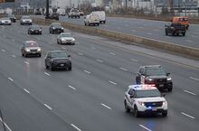 The procession for slain Ontario Provincial Const. Grzegorz Pierzchala makes its way northbound on Highway 400 in Toronto on Friday, December 30, 2022.  THE CANADIAN PRESS/ Tijana Martin