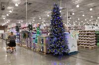 A lone shopper pushes a cart past a display for Christmas sales in a Costco warehouse late Thursday, Sept. 23, 2021, in Lone Tree, Colo.