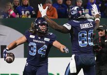 Toronto Argonauts running back AJ Ouellette (34) celebrates his touchdown with wide receiver DaVaris Daniels (80) during second half football action against the Winnipeg Blue Bombers in the 109th Grey Cup at Mosaic Stadium in Regina, Sunday, Nov. 20, 2022. THE CANADIAN PRESS/Heywood Yu