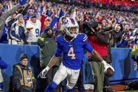 Buffalo Bills running back James Cook (4) scores a touchdown and celebrates against the Dallas Cowboys in an NFL football game, Sunday, Dec. 17, 2023, in Orchard Park, NY. (AP Photo/Jeff Lewis)