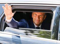FILE PHOTO: French President Emmanuel Macron waves as he votes in the first round of French parliamentary elections, at a polling station in Le Touquet, France, June 12, 2022.  Ludovic Marin/Pool via REUTERS/File Photo
