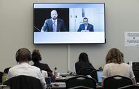 Reporters work as a television shows Commission Counsel John Mather questioning Jeremy MacKenzie as he appears by videoconference at the Public Order Emergency Commission, Friday, Nov. 4, 2022 in Ottawa. THE CANADIAN PRESS/Adrian Wyld
