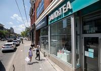 Pedestrians pass a DavidsTea shop on Queen Street West in Toronto on July 8, 2020.