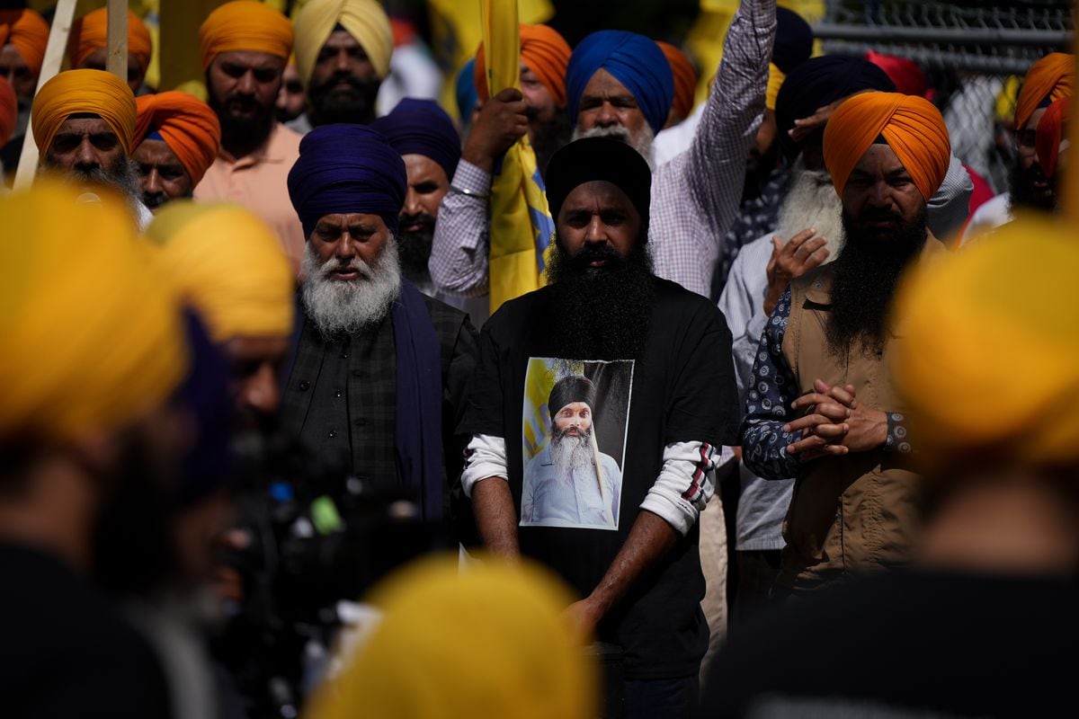 A mourner wears a T-shirt bearing a photograph of Sikh community leader and temple president Hardeep Singh Nijjar in Surrey, B.C., on June 25, 2023. N