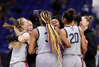 SAN ANTONIO, TEXAS - MARCH 29: The UConn Huskies celebrate defeating the Baylor Lady Bears 69-67 in the Elite Eight round of the NCAA Women's Basketball Tournament at the Alamodome on March 29, 2021 in San Antonio, Texas. (Photo by Carmen Mandato/Getty Images)