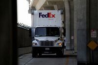 FILE PHOTO: A FedEx Ground truck drives near a FedEx regional hub at Los Angeles International Airport (LAX) in Los Angeles, California, U.S., September 16, 2022.  REUTERS/Bing Guan/File Photo