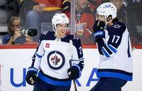 Winnipeg Jets forward Nikolaj Ehlers, left, celebrates his goal with teammate Adam Lowry during first period NHL pre-season hockey action against the Calgary Flames in Calgary, on Oct. 7, 2022. The Jets have placed Ehlers on injured reserve, retroactive to Tuesday. The winger will miss at least Saturday's visit from the Toronto Maple Leafs and Monday's tilt with the St. Louis Blues. THE CANADIAN PRESS/Jeff McIntosh
