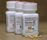 Bottles of prescription painkiller OxyContin pills, made by Purdue Pharma LP sit on a counter at a local pharmacy in Provo, Utah, on April 25, 2017.
