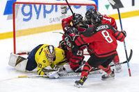 Canada's Caitlin Kraemer, centre, celebrates with teammates after scoring  past Sweden's goalkeeper Felicia Frank, left, during the Women's U18 Ice Hockey World Championship match between Canada and Sweden at the Ostersund Arena, in Ostersund, Sweden, Sunday, Jan. 15, 2023. (Per Danielsson/TT News Agency via AP)
