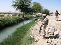 Canadian soldiers stand beside a canal near the village of Charbagh on the outskirts of Kandahar in this Oct. 3, 2009 photo.&nbsp;Canadians who served in Afghanistan say many of their Afghan family members don't qualify to come to Canada, even though their lives are at risk.&nbsp;THE CANADIAN PRESS/Bill Graveland