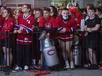 Montreal Canadiens fans look on outside the Bell Centre in Montreal, Friday, July 2, 2021, during Game 3 of the NHL Stanley Cup final against the Tampa Bay Lightning. THE CANADIAN PRESS/Graham Hughes