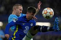 Malmo's Franz Brorsson, left, is challenged by Chelsea's Mason Mount during the Champions League group H soccer match between Chelsea and Malmo at the Stamford Bridge stadium in London, Wednesday, Oct. 20, 2021. (AP Photo/Alastair Grant)