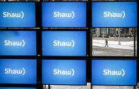 Shaw logos on display at the company's annual meeting in Calgary, Jan. 17, 2019. Rogers Communications Inc. has signed a deal to buy Shaw Communications Inc. in a deal valued at $26 billion, including debt. THE CANADIAN PRESS/Jeff McIntosh