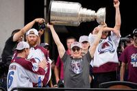 Colorado Avalanche defenseman Cale Makar lifts the Stanley Cup during a rally outside the City/County Building for the NHL hockey champions after a parade through the streets of downtown Denver, Thursday, June 30, 2022, in Denver. (AP Photo/David Zalubowski)