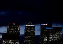 Citibank, HSBC and Barclays buildings are lit up at dusk in the Canary Wharf financial district of London, Britain, November 19, 2018.