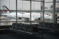 A plane&nbsp;on the tarmac is seen through the window of an empty waiting room at Vancouver International Airport, in Richmond, B.C., Tuesday, June 9, 2020. Air Canada is seeking the dismissal of the U.S. Department of Transportation's US$25.5-million fine over the airline's alleged failure to provide prompt refunds after cancelling their flights amid the COVID-19 pandemic dismissed. THE CANADIAN PRESS/Jonathan Hayward