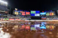 Attendees at the Yankee Stadium wait out a rain delay ahead the Game 5 of an American League Division baseball series between the Cleveland Guardians and the New York Yankees in New York, on Monday, Oct. 17, 2022. (Victor J. Blue/The New York Times)