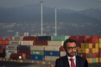 Minister of Transport Omar Alghabra listens during an announcement at Port Metro Vancouver's Centerm container terminal, in Vancouver, B.C., Friday, Oct. 14, 2022. Four federal Liberal MPs have written to Alghabra expressing frustration with a much-criticized program that aims to replace older trucks that service the Vancouver Port Authority. THE CANADIAN PRESS/Darryl Dyck