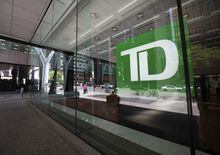 TD bank signs seen behind the window of a branch in Toronto’s Financial District are photographed on July 12, 2022. Fred Lum/The Globe and Mail. 