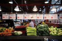 People shop for produce at the Granville Island Market in Vancouver, on Wednesday, July 20, 2022. Canada's inflation rate was up 8.1 per cent in June compared with a year ago, its largest yearly change since January 1983. THE CANADIAN PRESS/Darryl Dyck