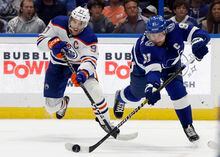 wNov 8, 2022; Tampa, Florida, USA; Tampa Bay Lightning center Steven Stamkos (91) passes as Edmonton Oilers center Connor McDavid (97) defends during the third period at Amalie Arena. Mandatory Credit: Kim Klement-USA TODAY Sports