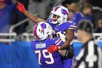DETROIT, MICHIGAN - NOVEMBER 20: Spencer Brown #79 of the Buffalo Bills celebrates with Devin Singletary #26 of the Buffalo Bills after Singletary's touchdown during the third quarter against the Cleveland Browns at Ford Field on November 20, 2022 in Detroit, Michigan. (Photo by Gregory Shamus/Getty Images)