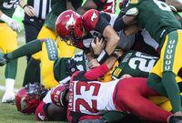 Calgary Stampeders quarterback Tommy Stevens (15) dives in over players for the touchdown against the Edmonton Elks during first half CFL action in Edmonton, Alta., on Saturday September 10, 2022. THE CANADIAN PRESS/Jason Franson.