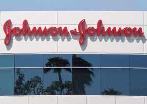(FILES) In this file photo taken on August 28, 2019 A sign on a building at the Johnson & Johnson campus shows their logo in Irvine, California. - Johnson & Johnson proposes $8.9 billion settlement of talc cancer claims. (Photo by Mark RALSTON / AFP) (Photo by MARK RALSTON/AFP via Getty Images)