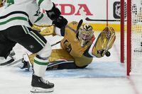 Vegas Golden Knights goaltender Adin Hill (33) blocks a shot with his glove by Dallas Stars left wing Joel Kiviranta, left, during the third period of Game 5 of the NHL hockey Stanley Cup Western Conference finals Saturday, May 27, 2023, in Las Vegas. (AP Photo/John Locher)